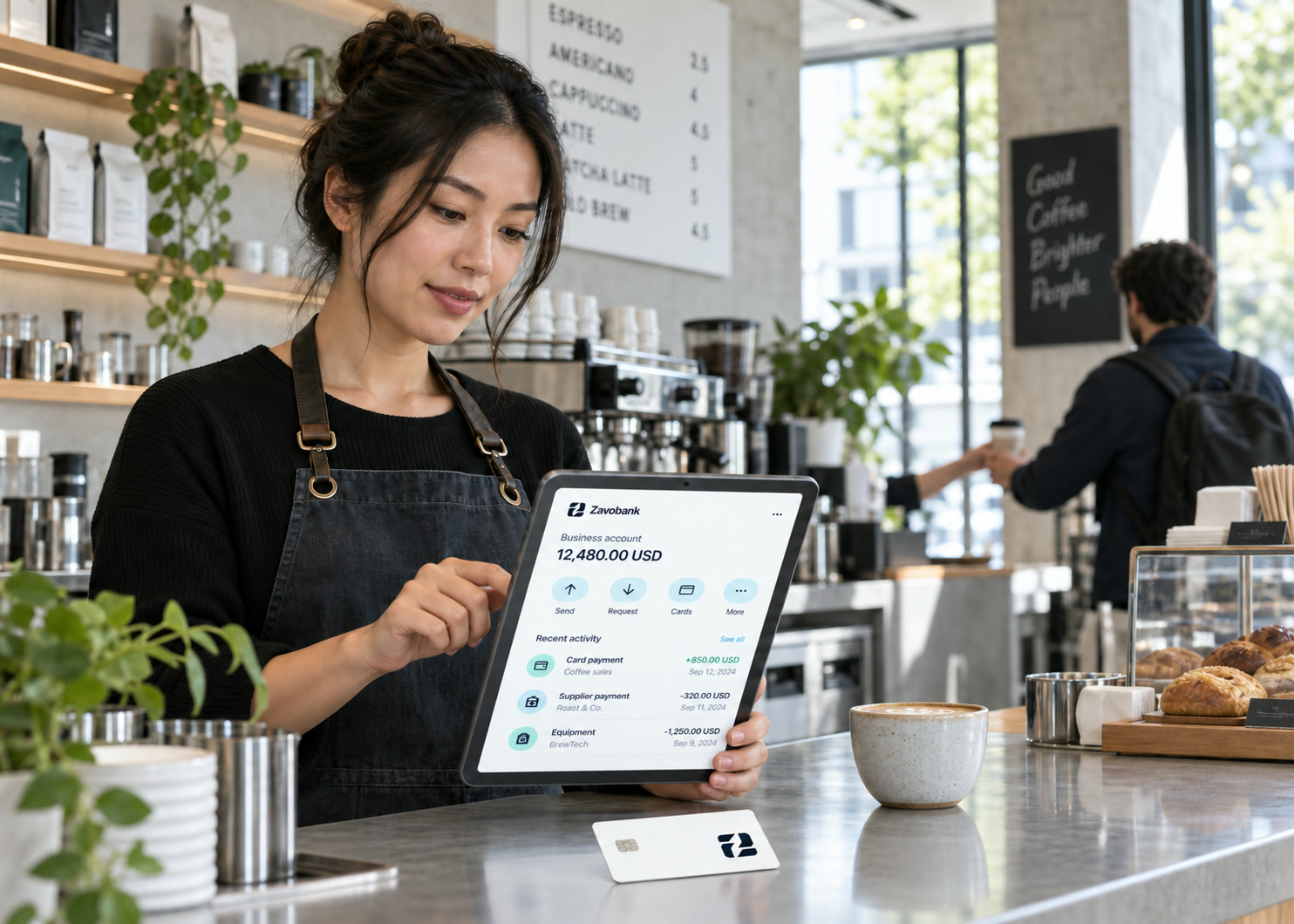 An independent cafe owner reviewing her Zavobank business account on a tablet